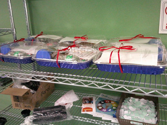 Birthday cake supplies in foil pans on shelf.